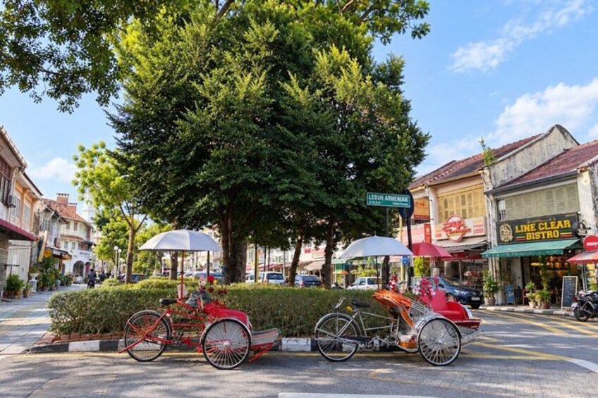 A street with a bicycle, a tree, and buildings. 5