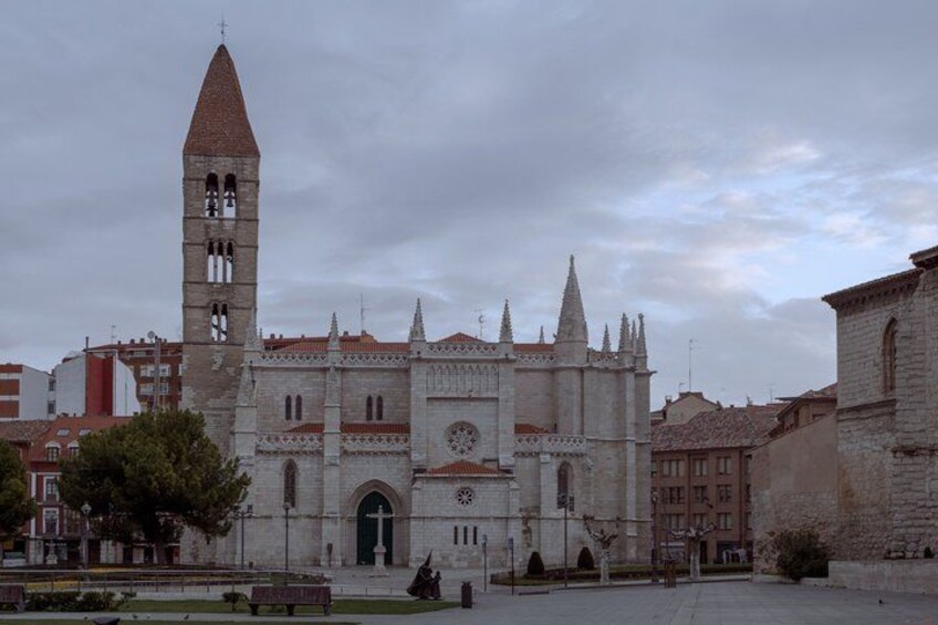 A historic cathedral with a tall bell tower, a large arched entrance, and a clock. 3