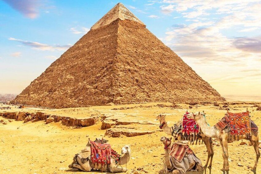 A pyramid, camels, and a desert landscape. 4