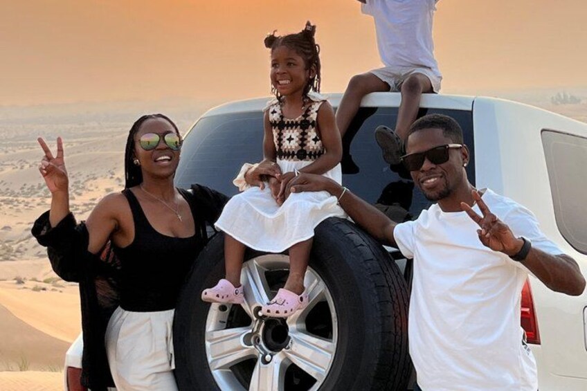 A family with a child on a vehicle in a desert landscape. 3