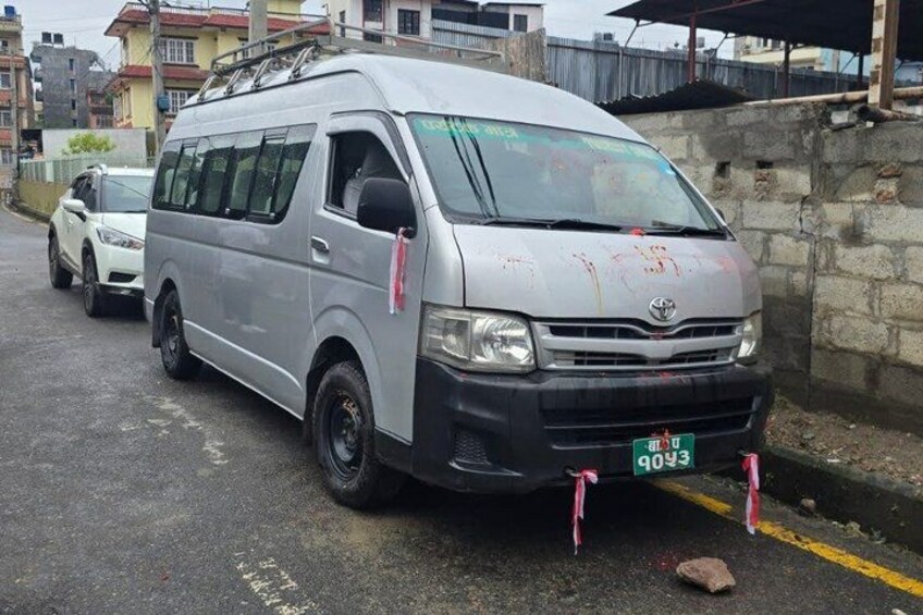 A silver van parked on a street with a license plate number 4043. 2