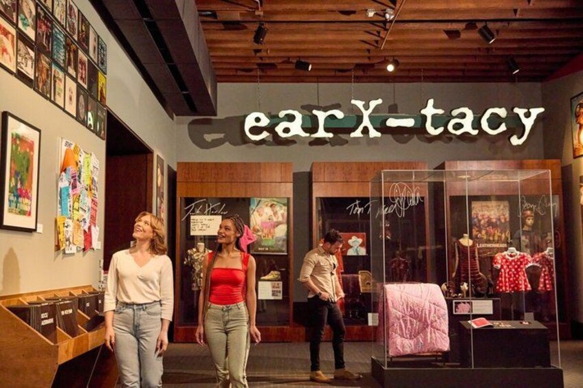 A store named earX-tacy with a modern interior, art on the walls, and mannequins displaying clothing. 3