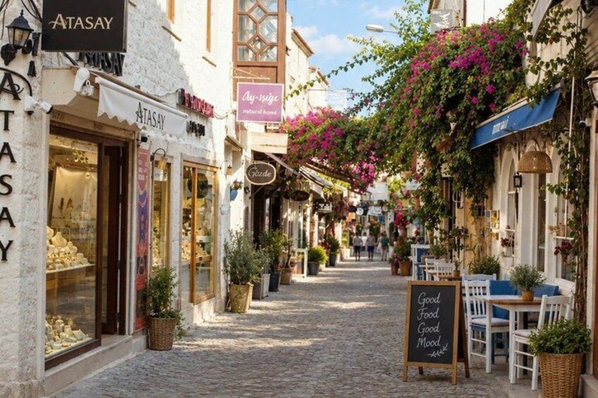 A cobblestone street lined with shops, including a store named 'Atasay'. 4