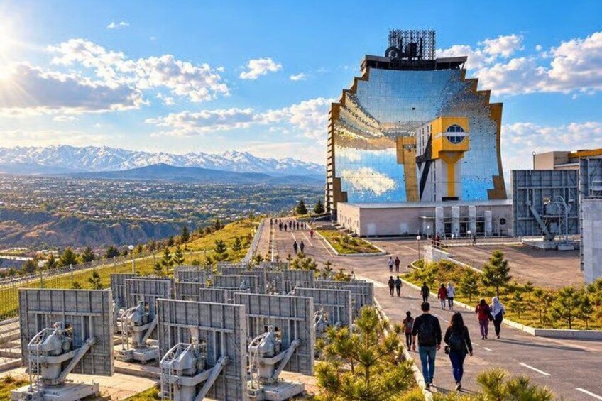 A modern building with a unique design, surrounded by a mountainous landscape and a clear sky. 5