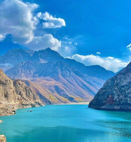 A mountain lake with clear turquoise water surrounded by rugged mountains. 1