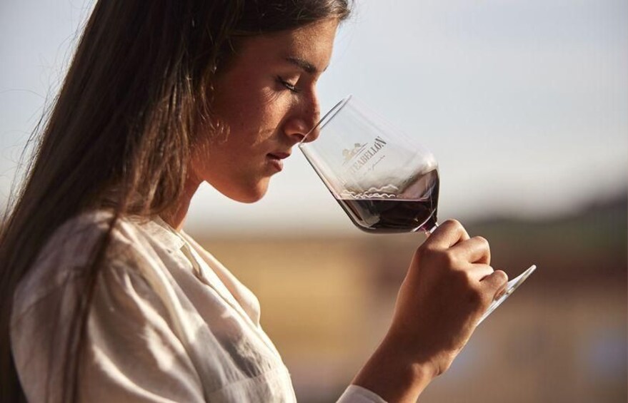A person holding a wine glass. 1