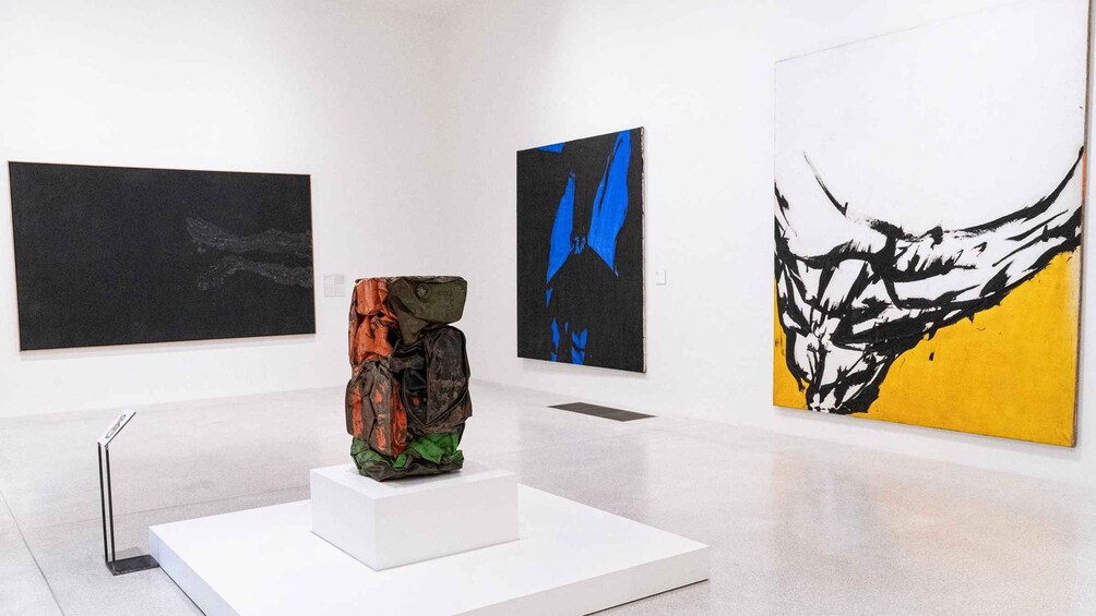 An art gallery with three paintings and a sculpture. 3
