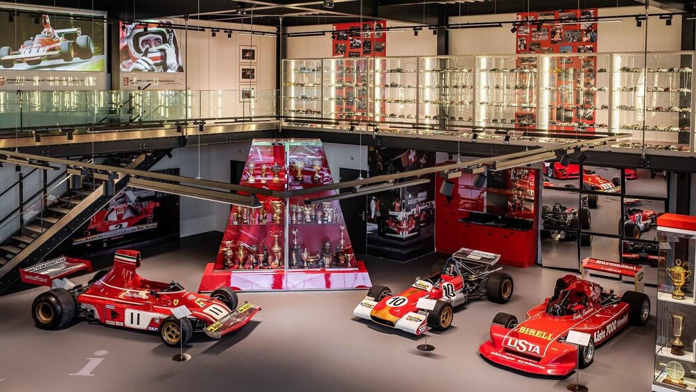 A museum with racing cars and trophies. 3