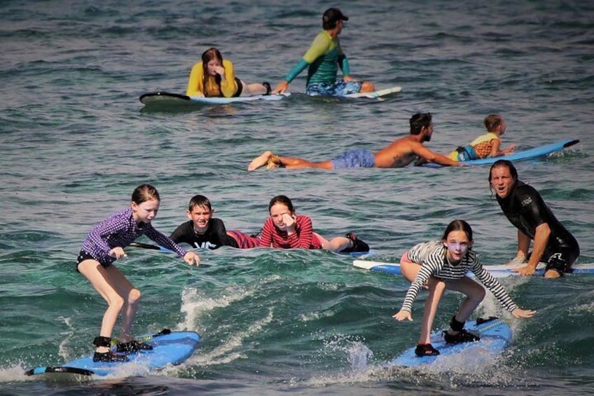 People surfing on blue boards in the ocean. 2