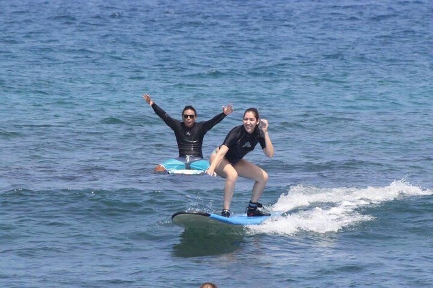 Two people surfing on a wave in the ocean. 5