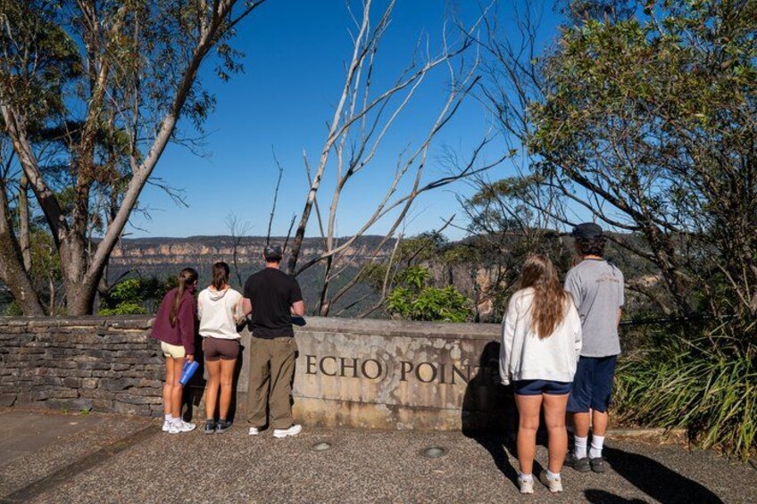 A group of people standing at Echo Point, overlooking a canyon. 2