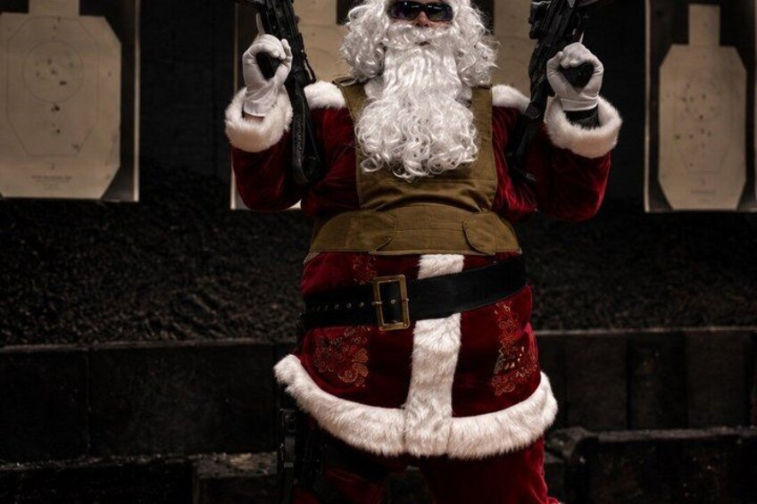 A person in a Santa Claus costume holding a gun. 3