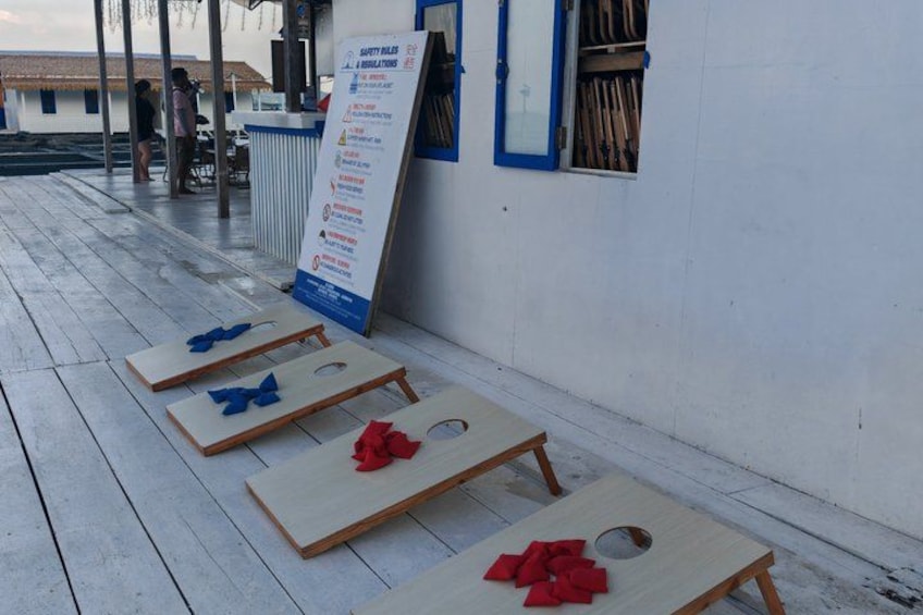A wooden floor with four small tables, each with a bow tied to it. 4