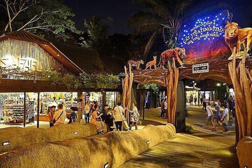 A nighttime outdoor market with wooden structures and a sign that reads 'CAT TIKING TIME.' 1