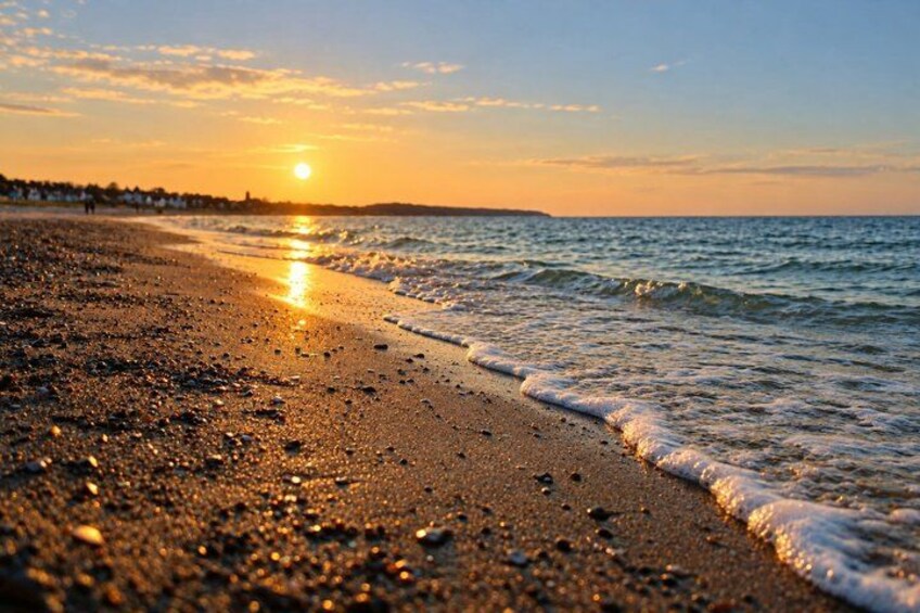A beach at sunset with the sun reflecting on the water. 5