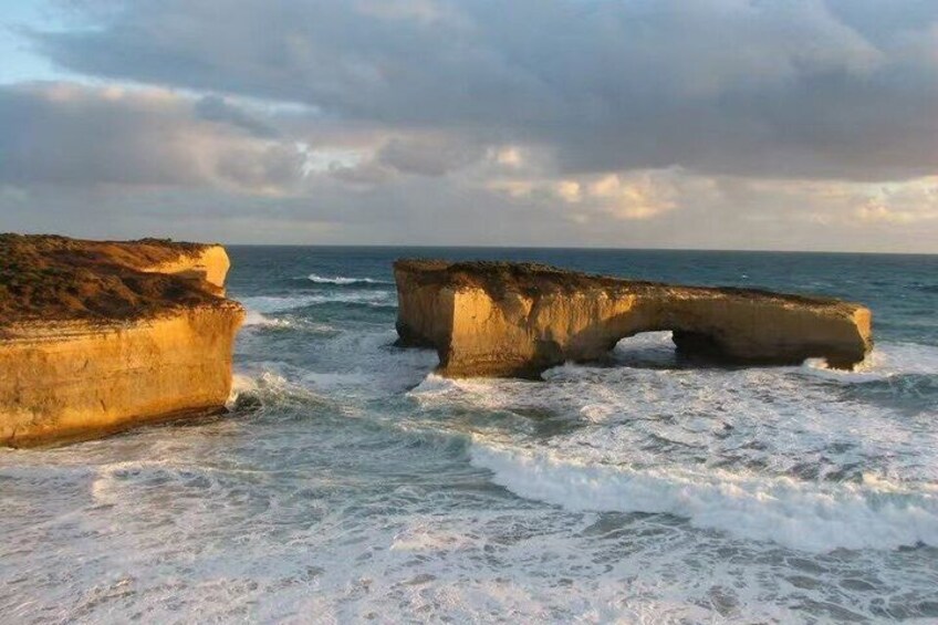 A coastal landscape with large rock formations and waves. 3