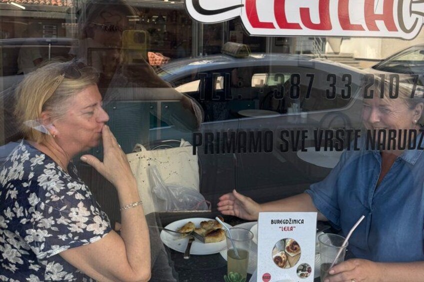 A person sitting at a table with a plate of food and a drink. 3
