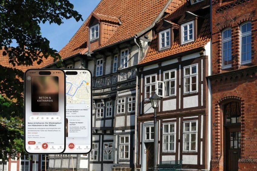 A historic building with a red-tiled roof and white-framed windows. 1