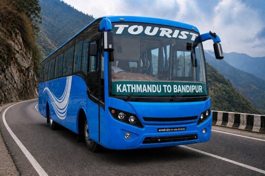 A blue bus with 'TOURIST' and 'Kathmandu to Bandipur' written on it, driving on a winding mountain road. 2