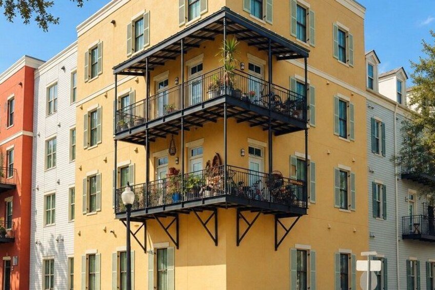 A multi-story building with balconies, windows, and a street lamp. 4