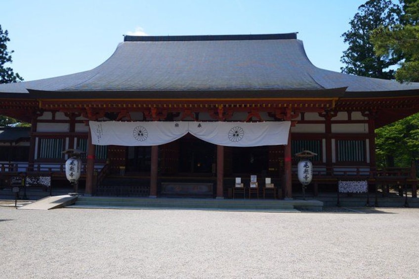 A traditional Japanese building with a curved roof and a white awning. 3