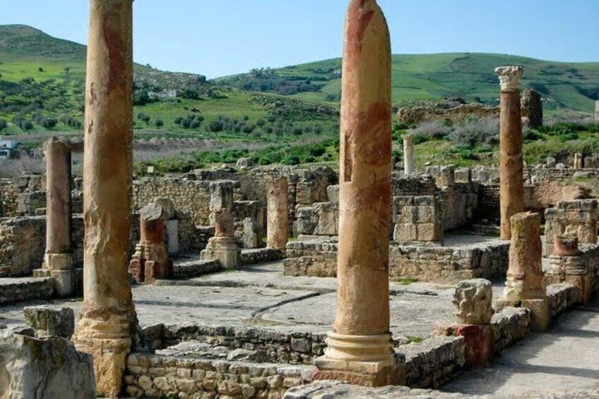 Ancient ruins with columns and stone structures. 4