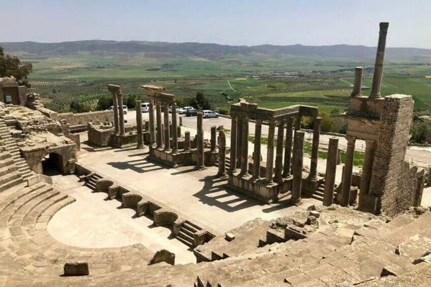 Ancient ruins with columns and a partially intact amphitheater. 2