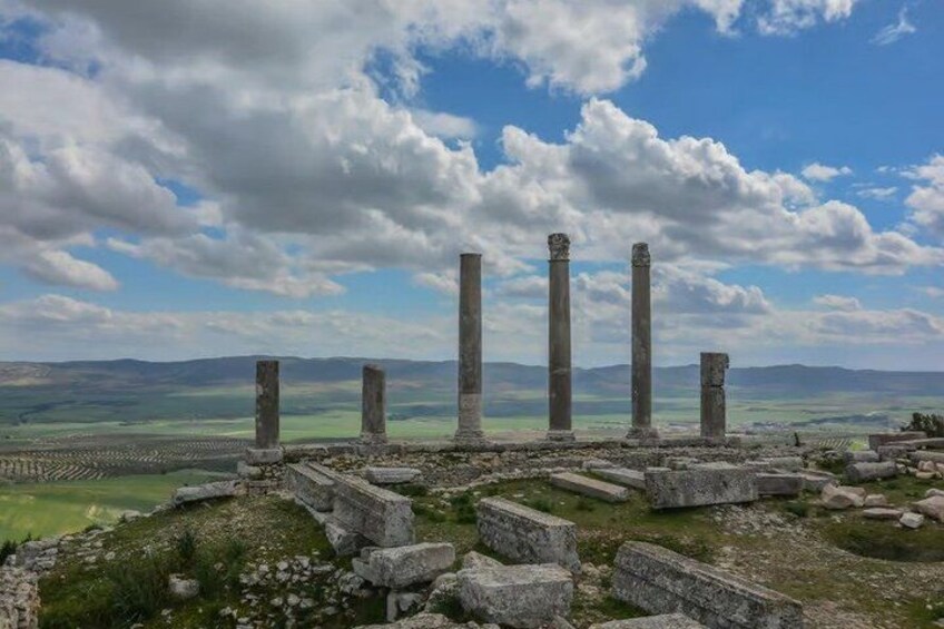 Ancient ruins with columns and stone structures. 5