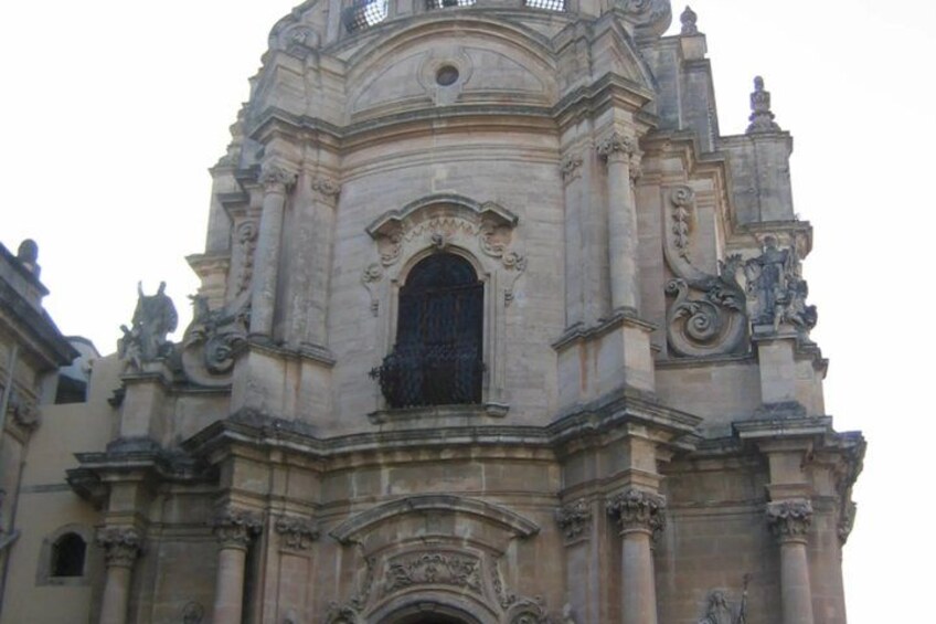 A historic stone building with ornate carvings and statues. 2