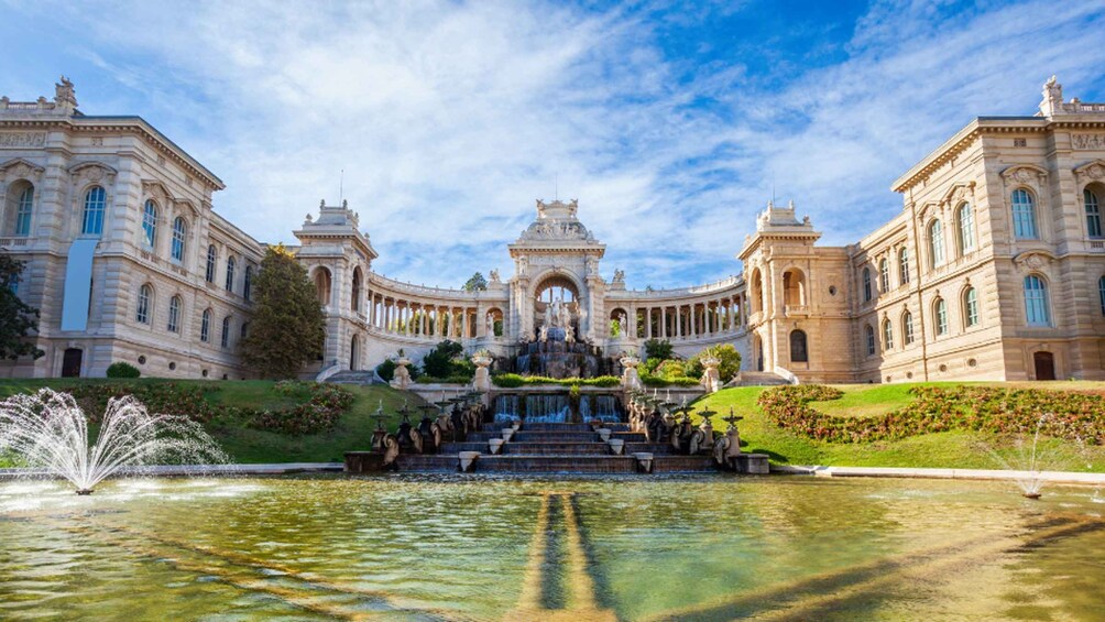 A grand palace with a central fountain, symmetrical architecture, and manicured gardens. 4