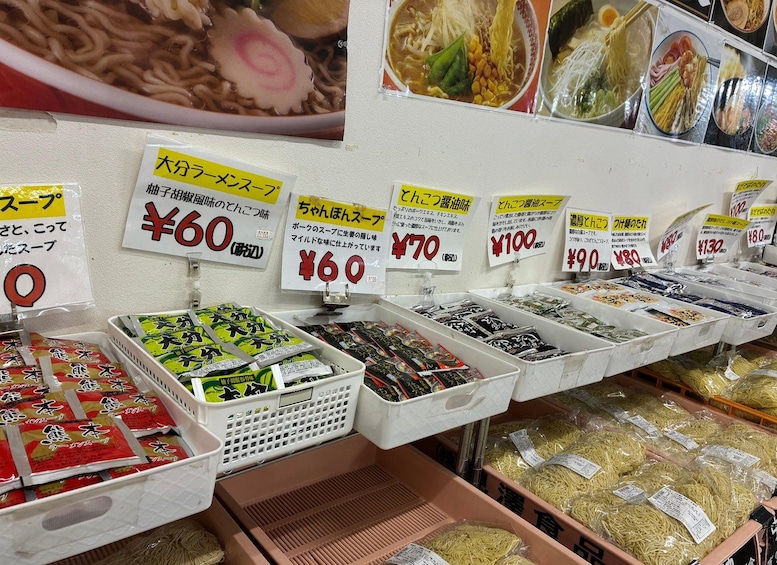 A variety of instant noodle packages with price tags in a store. 3