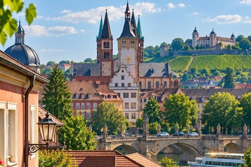 A historic town with a prominent church, a castle on a hill, and a bridge over a river. 5