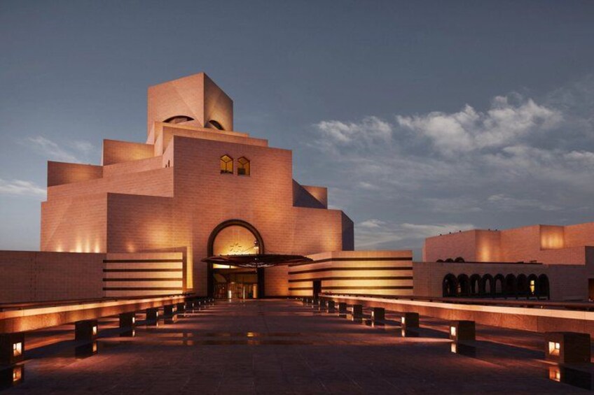 A large, modern building with a unique architectural design, featuring a central dome and multiple arches. 1