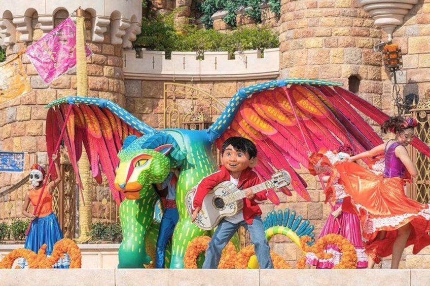 A colorful dragon, a person playing a guitar, and a person in a traditional dress. 4