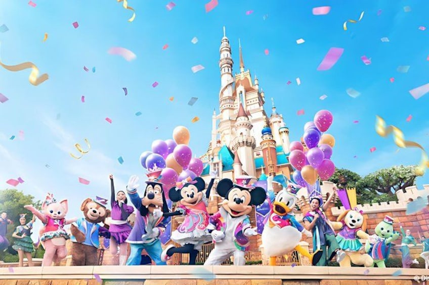 A group of animated characters in front of a castle with confetti in the air. 1