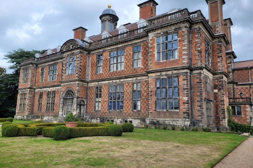 A large brick building with multiple windows and a dome on top. 2