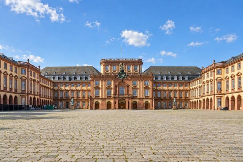 A large historic building with a central courtyard and symmetrical architecture. 5