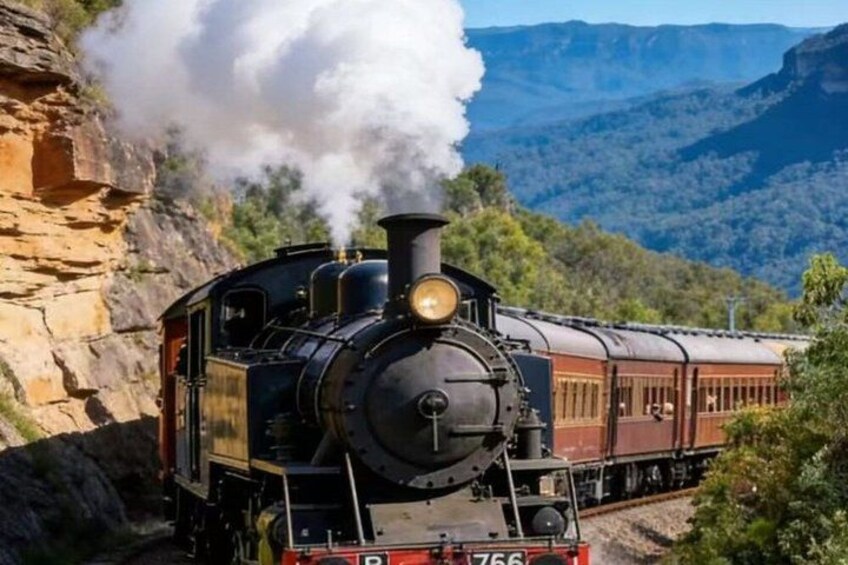 A steam locomotive with a red and black carriages, emitting steam, traveling through a mountainous landscape. 1