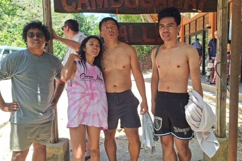 A group of people standing under a sign that reads 'CAMBODIAN ALL.' 2