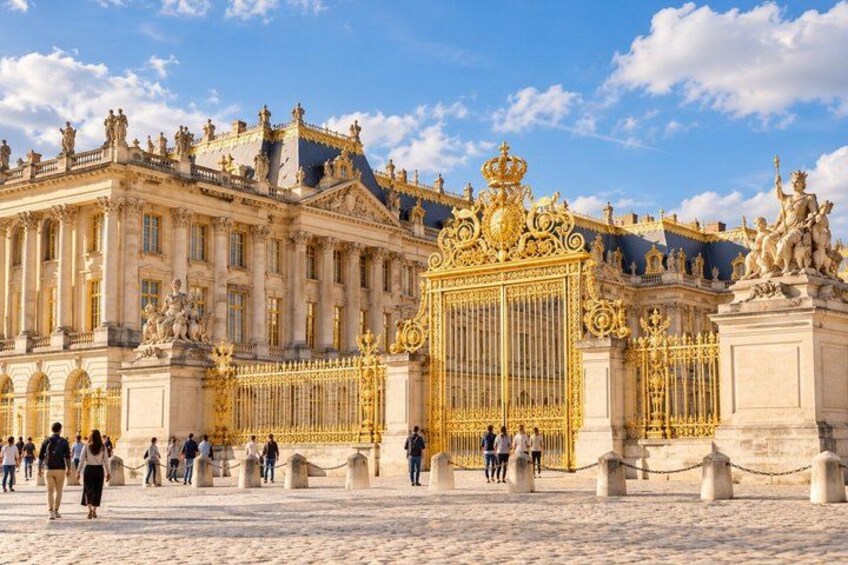 The ornate facade of a historic palace with intricate gold detailing and statues. 4