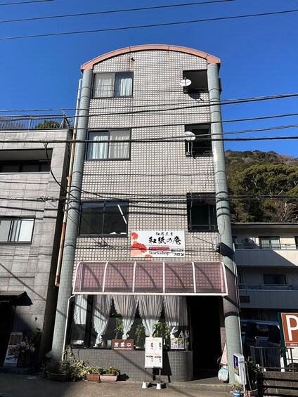 Un edificio de varios pisos con un letrero para un taller tradicional japonés. 4