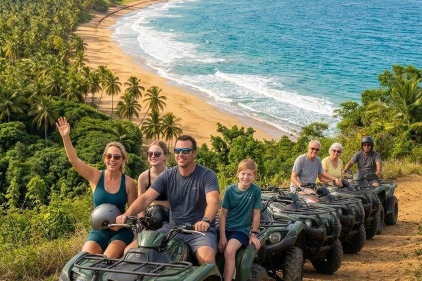 A group of people on ATVs on a beach with palm trees and ocean in the background. 2