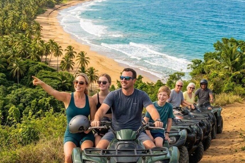 A group of people on ATVs on a beach with palm trees and ocean in the background. 5