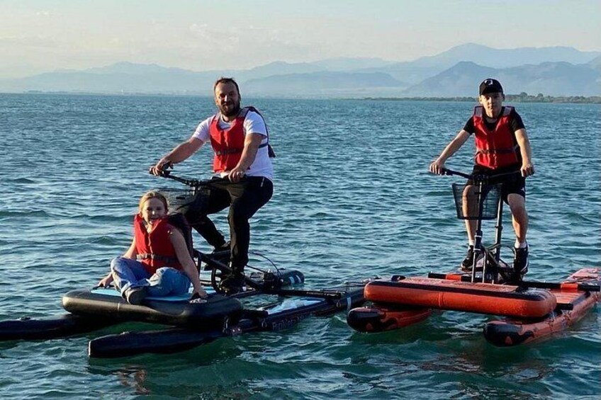 Three people on a boat, two adults and a child, wearing life jackets. 3
