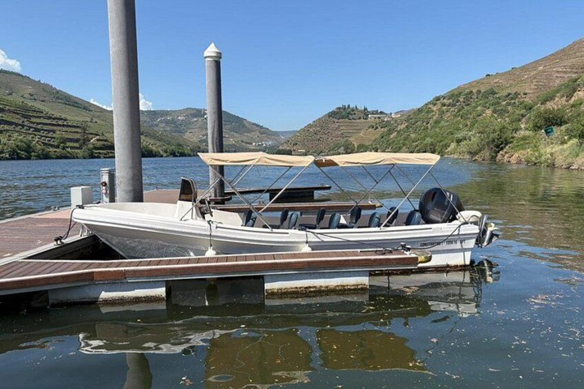 A boat docked at a pier with a mountainous landscape in the background. 3