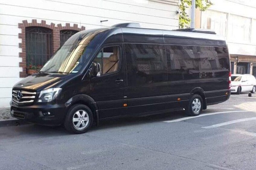 A black van parked on a city street. 1