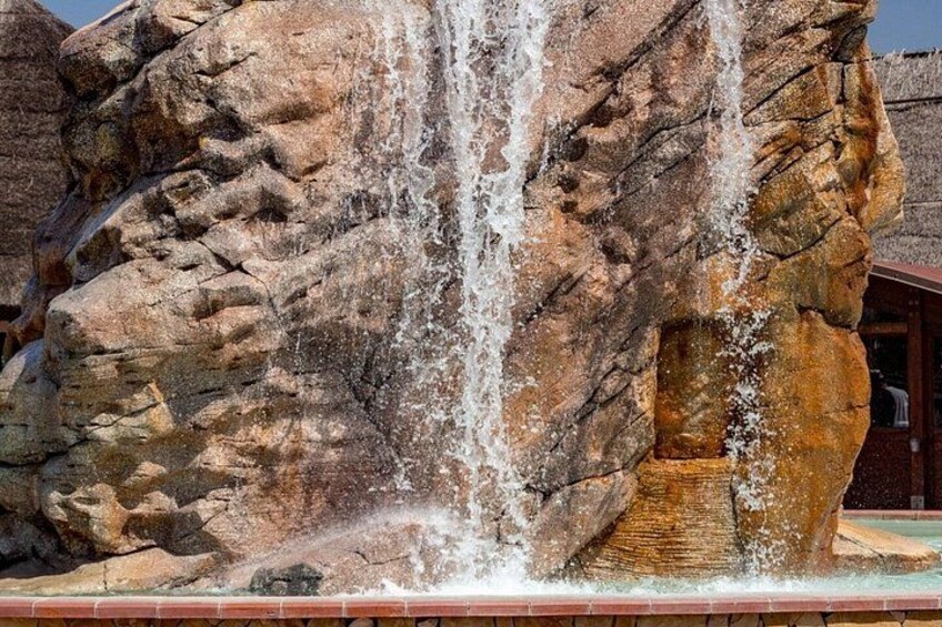 A rock formation with a waterfall. 5