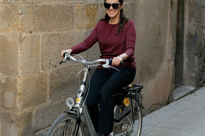 A person riding a bicycle on a paved path. 1