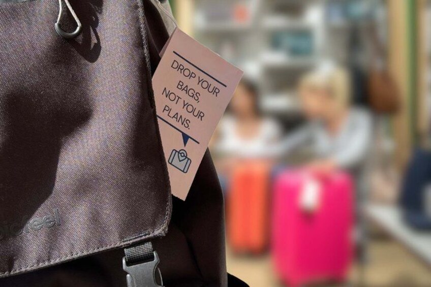 A brown bag with a tag that says 'DROP YOUR BAGS, NOT YOUR PLANS.' 5