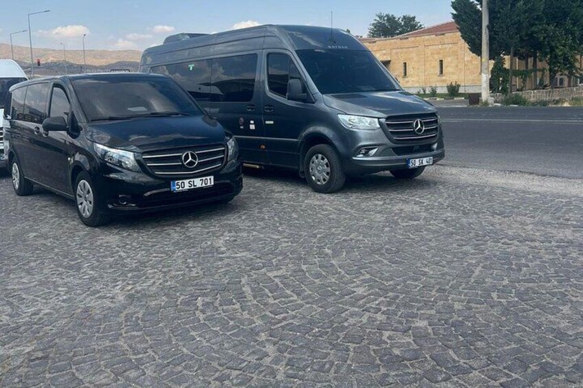 Two Mercedes-Benz vans parked on a cobblestone surface. 1